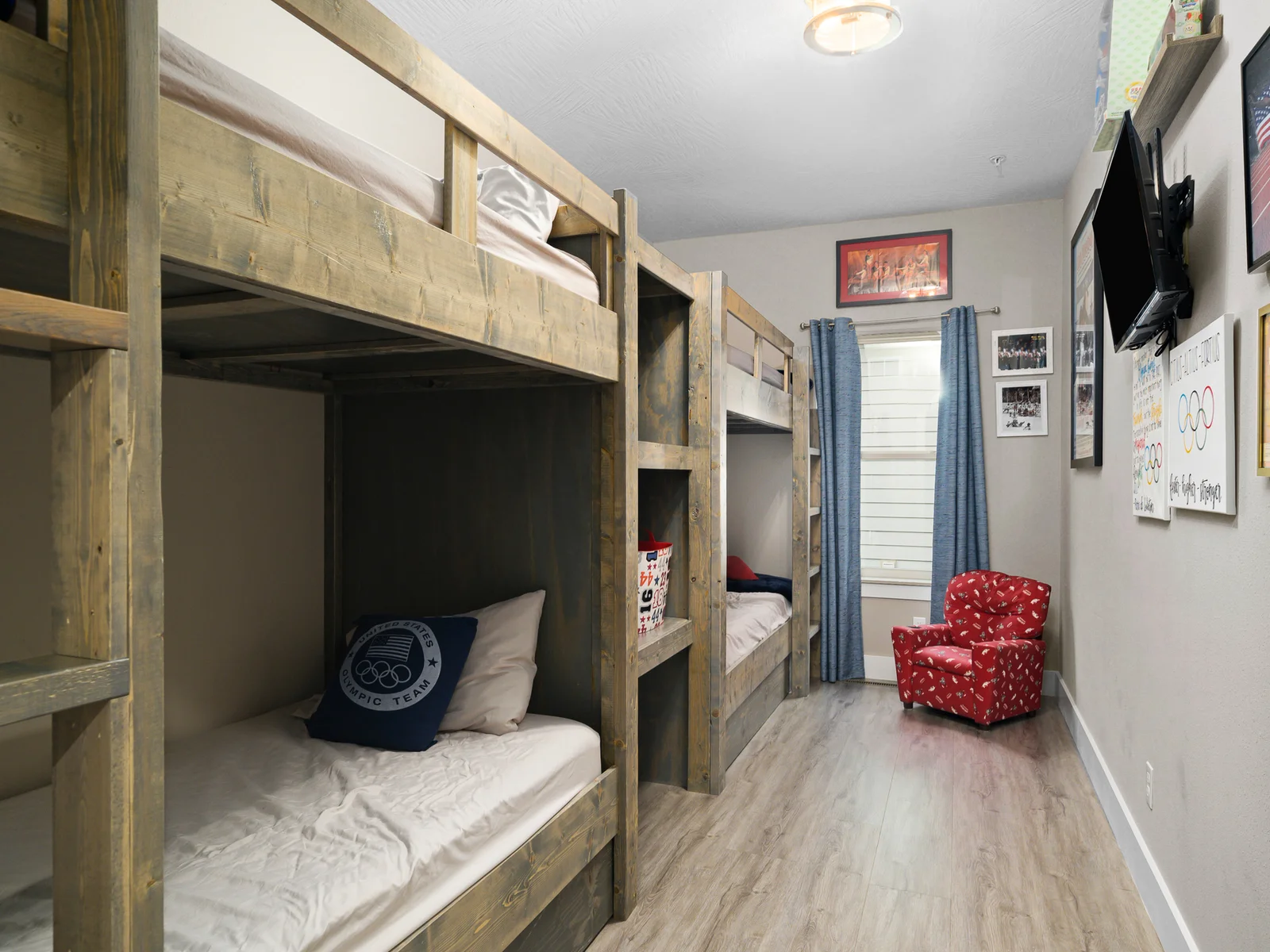 Main level: Olympic Dreams room with two built-in bunk beds, sleeps 4. Bathroom across the hall