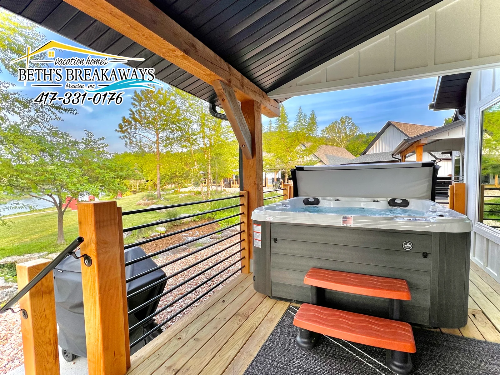 The back porch provides a relaxing hot tub, seating, and your own private grill!