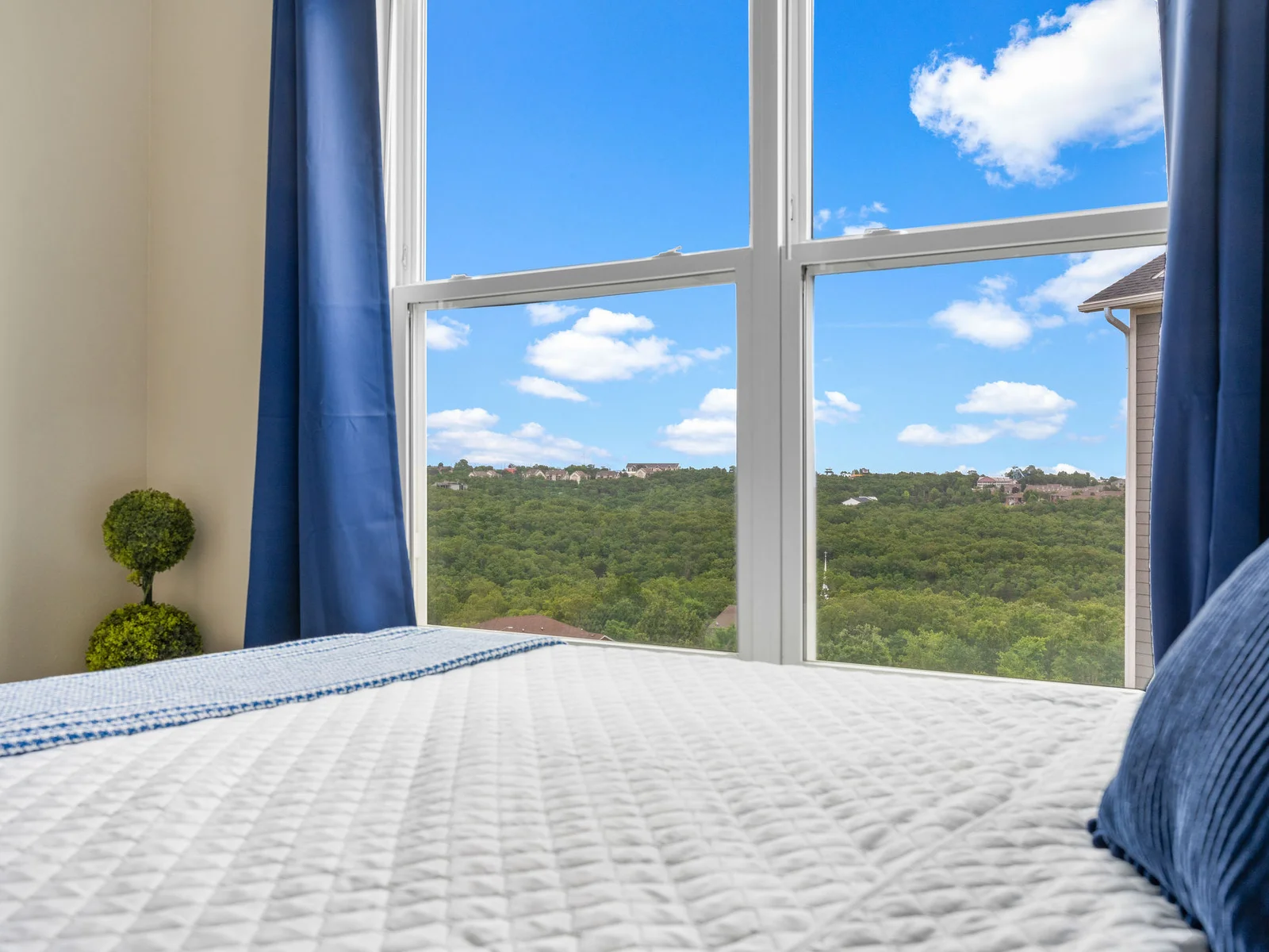 Wake up in the queen room to Ozark hills and a peek of the Branson 76 Strip out the window — a real view, not a parking lot.