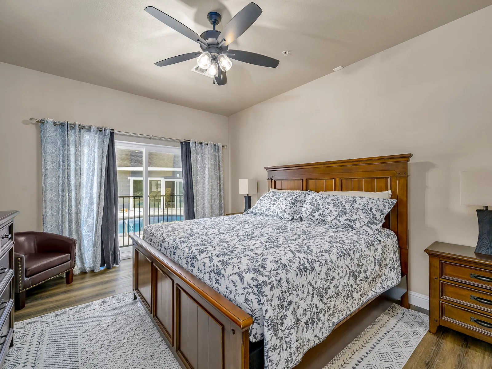 Main level king suite #2 with slider out to pool area and ensuite bathroom. There are a total of 4 stairs to navigate down to reach this bedroom.