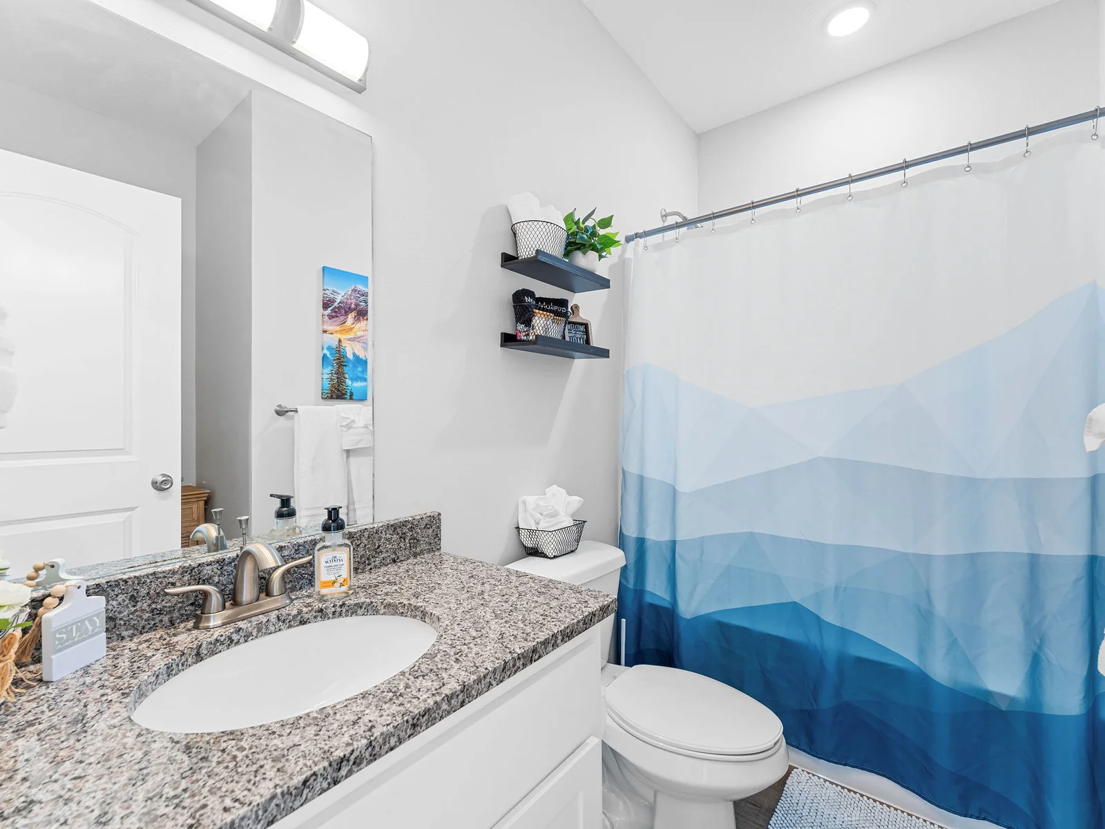 Find complimentary toiletries stocked and ready — the full bathroom is clean, bright, and covers everything you forgot to pack.