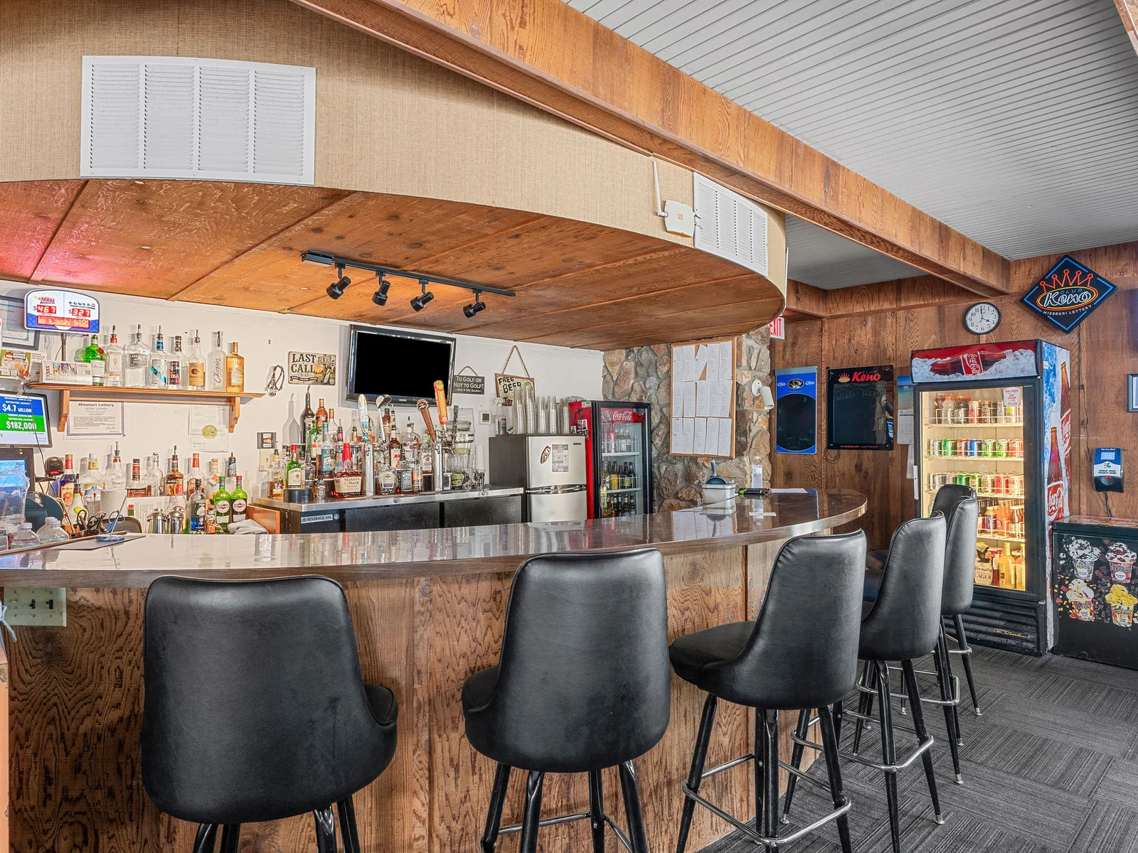 The community lounge and bar at Lost Woods Hideaway — a full drink menu and space to gather for evenings when you would rather let someone else do the pouring.