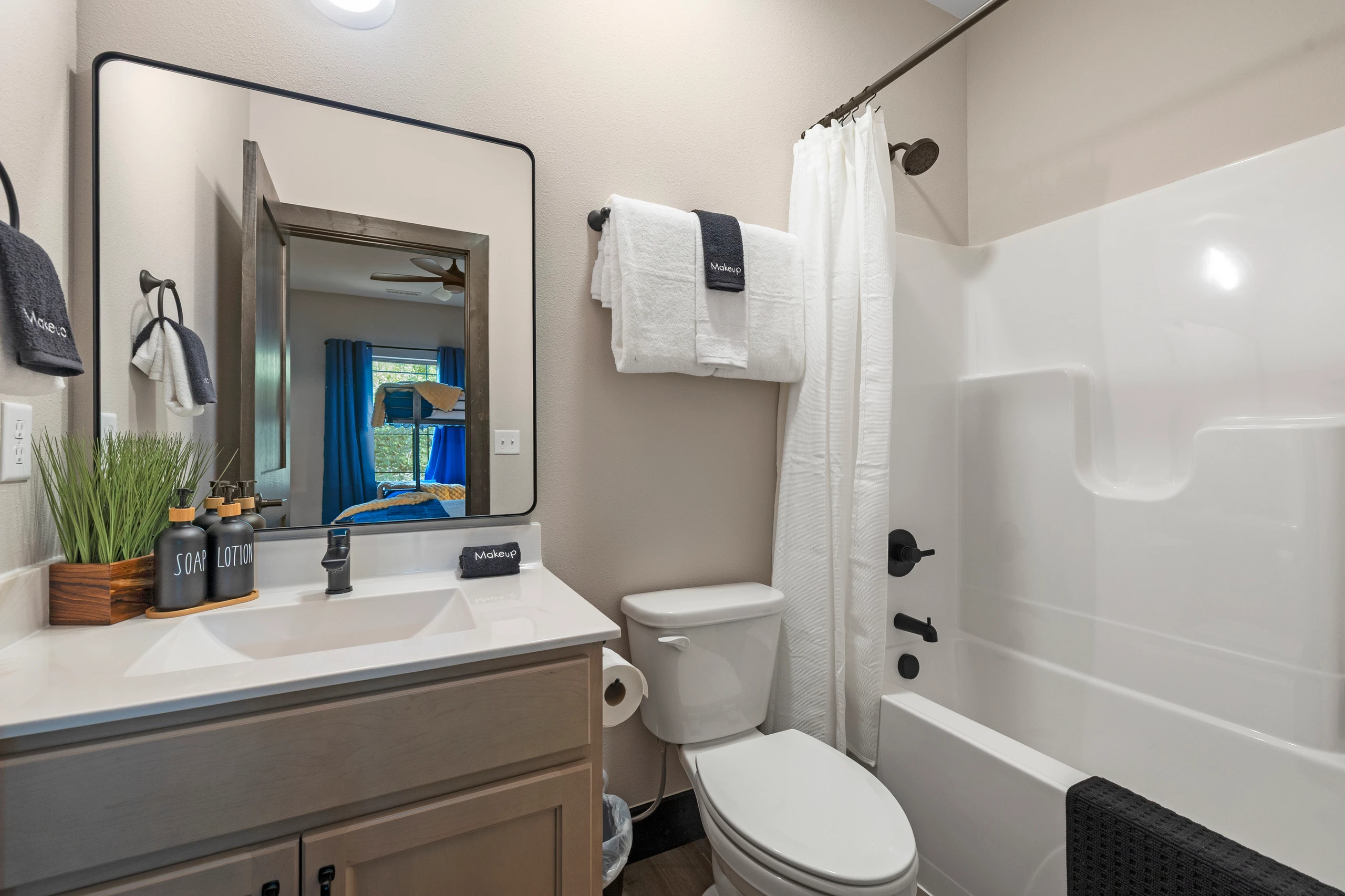 An ensuite with a tub-shower combo and fresh towels.
