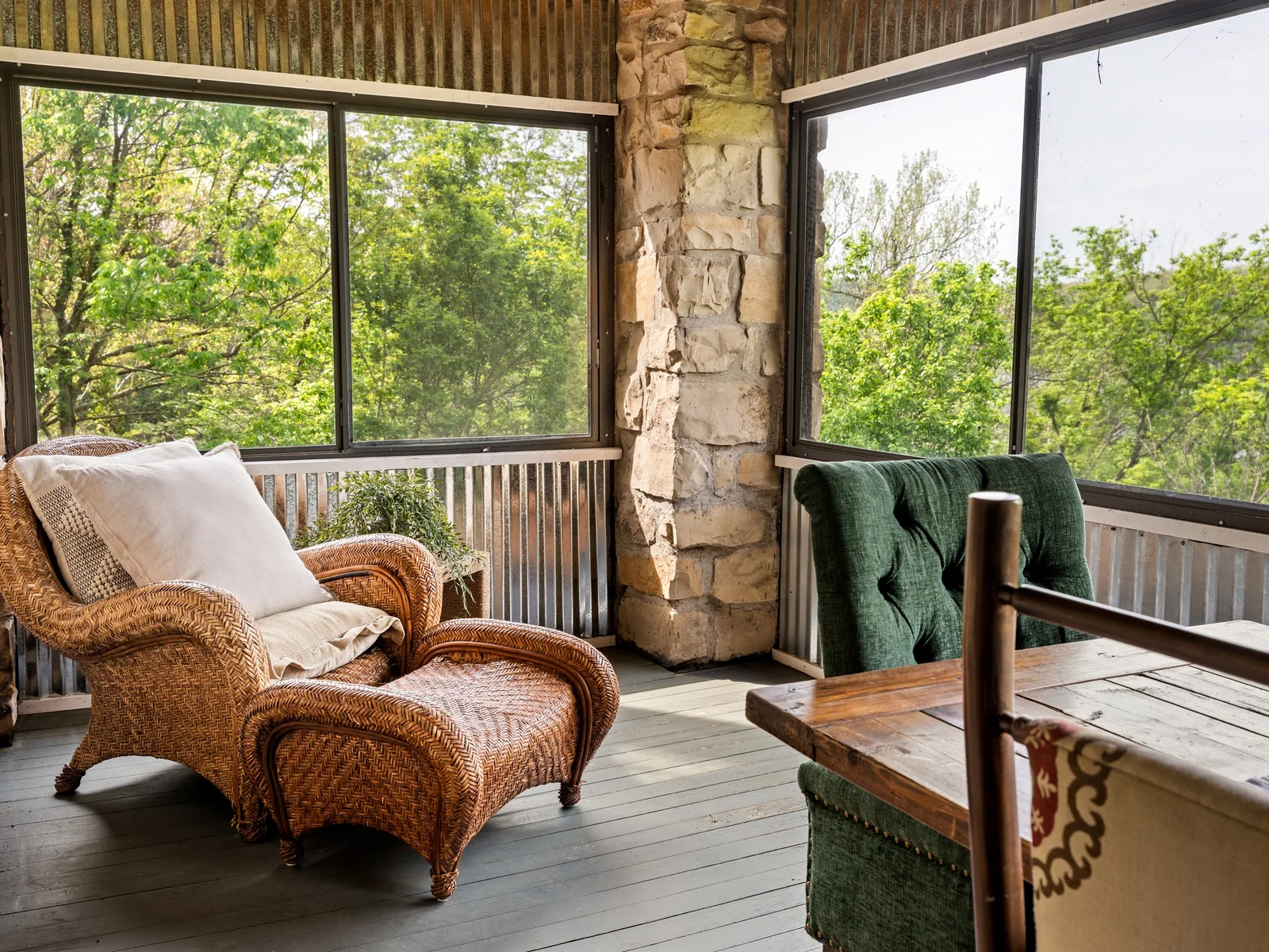 Cozy up with a book or morning coffee in this peaceful porch retreat.