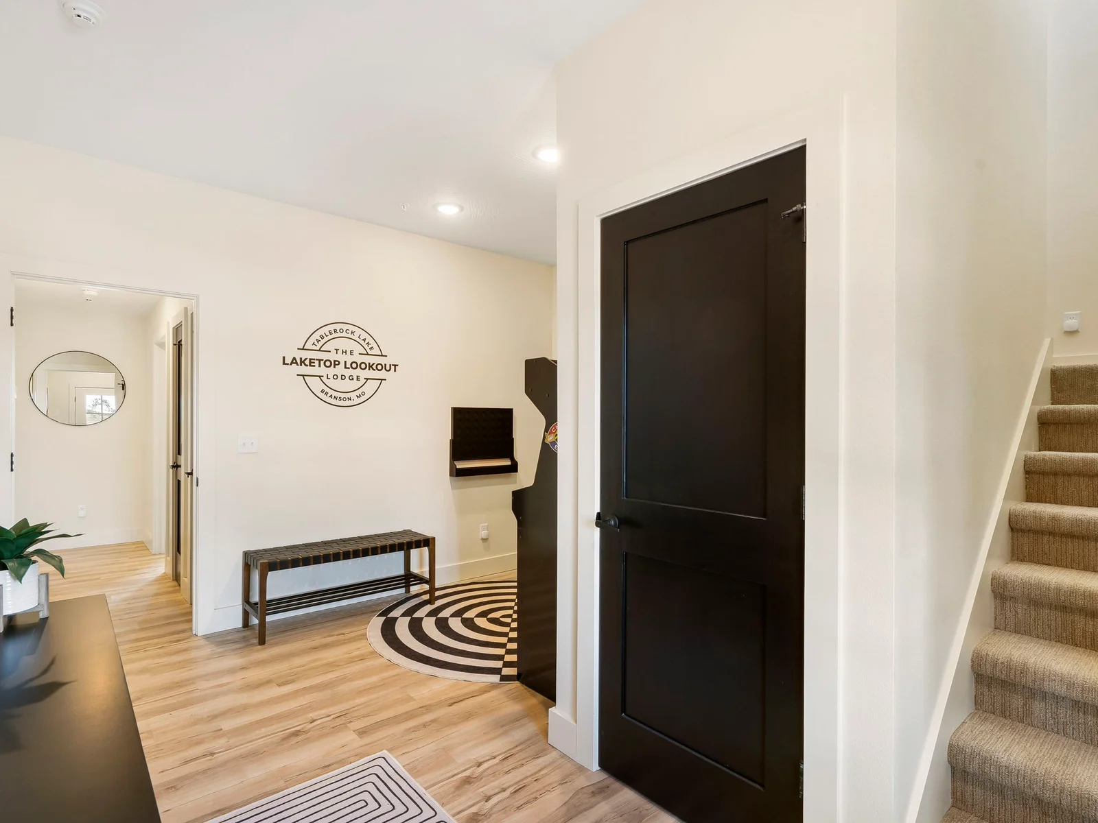 Entry level entertainment and bedrooms. Stairs lead up to the living room, kitchen, and dining plus one more bedroom.