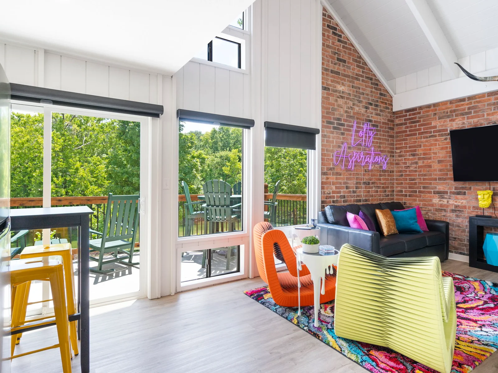 Open living and dining space with a walk-out porch overlooking a finger of Lake TaneyComo.
