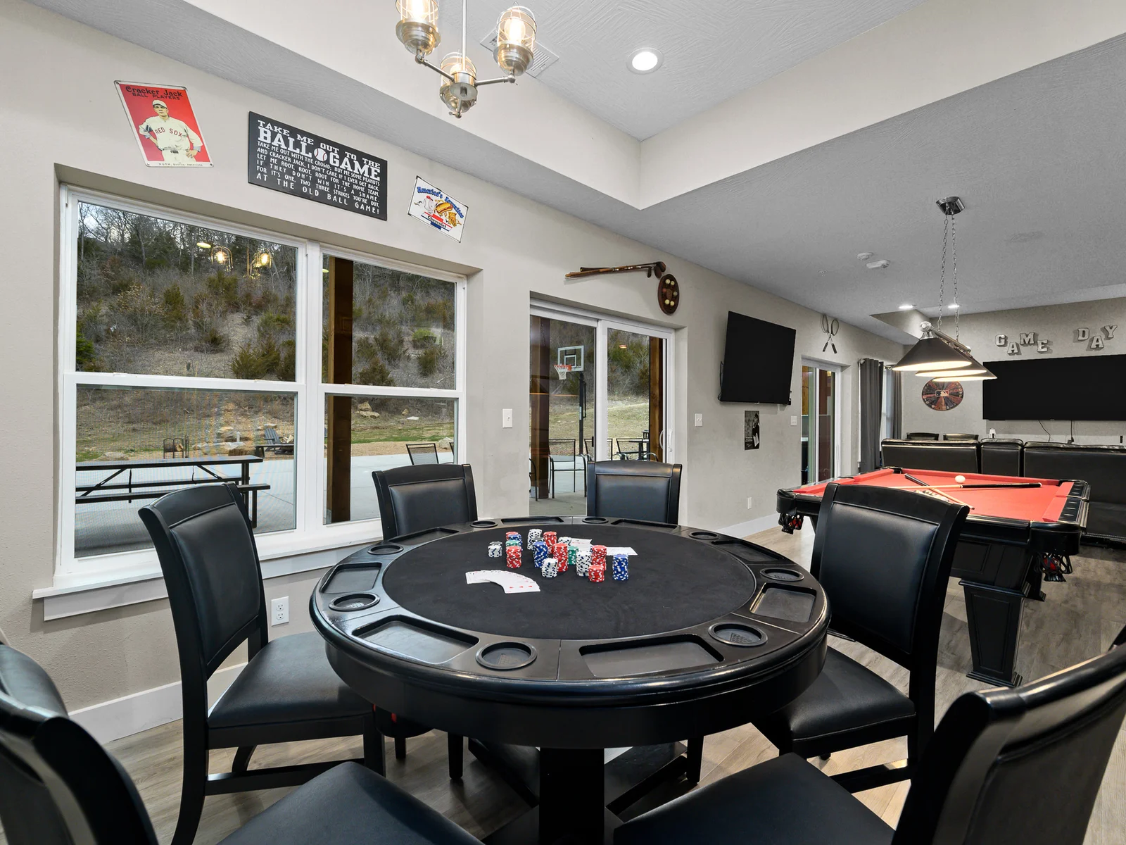 Game room with poker table and pool table.