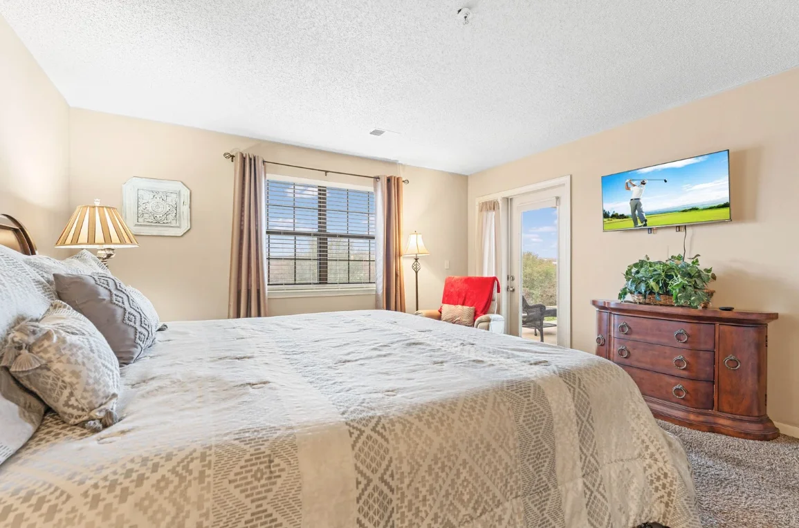 Primary bedroom with king bed and TV for relaxing nights.