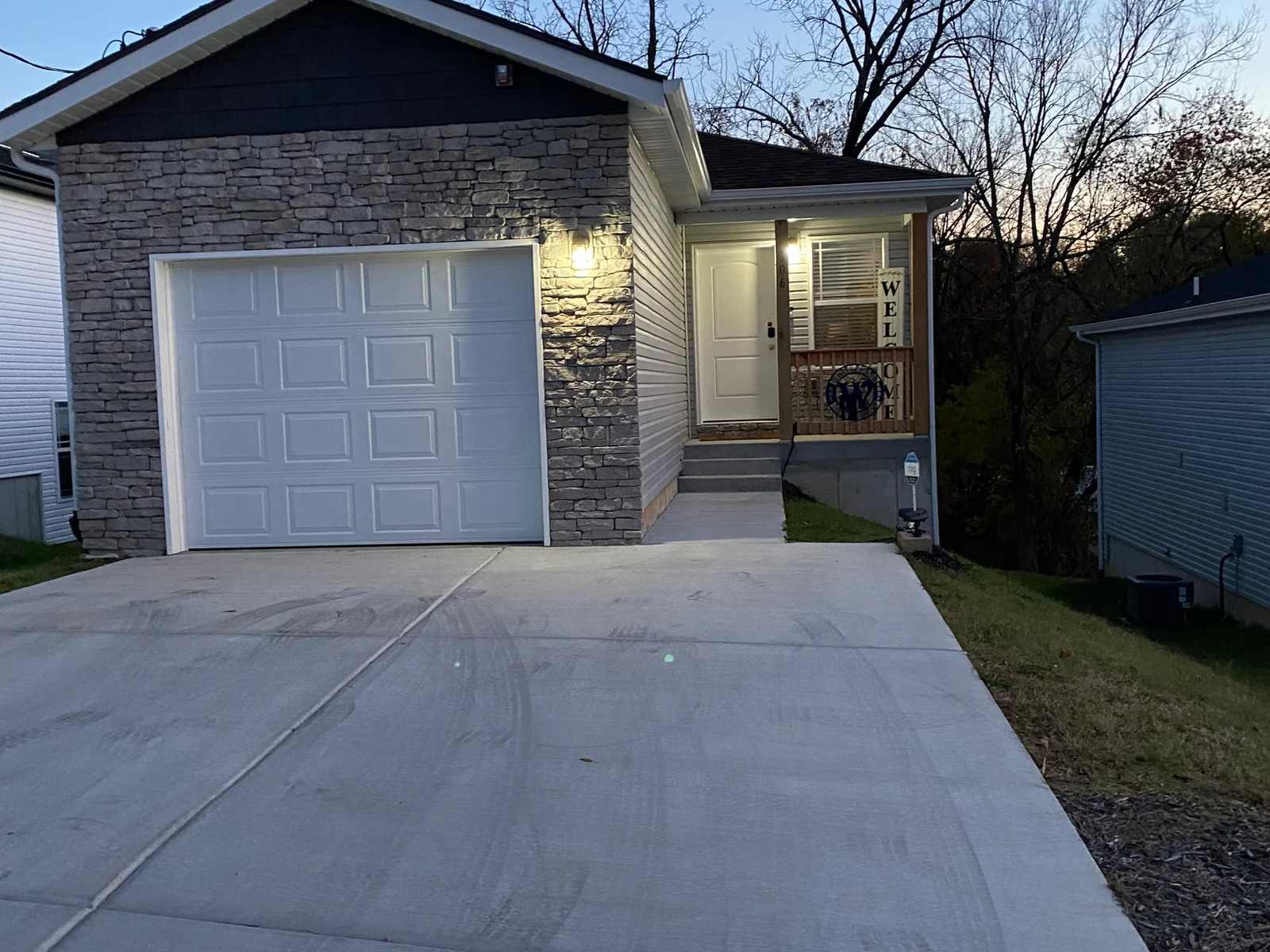 well lit entrance with additional security landscape lights