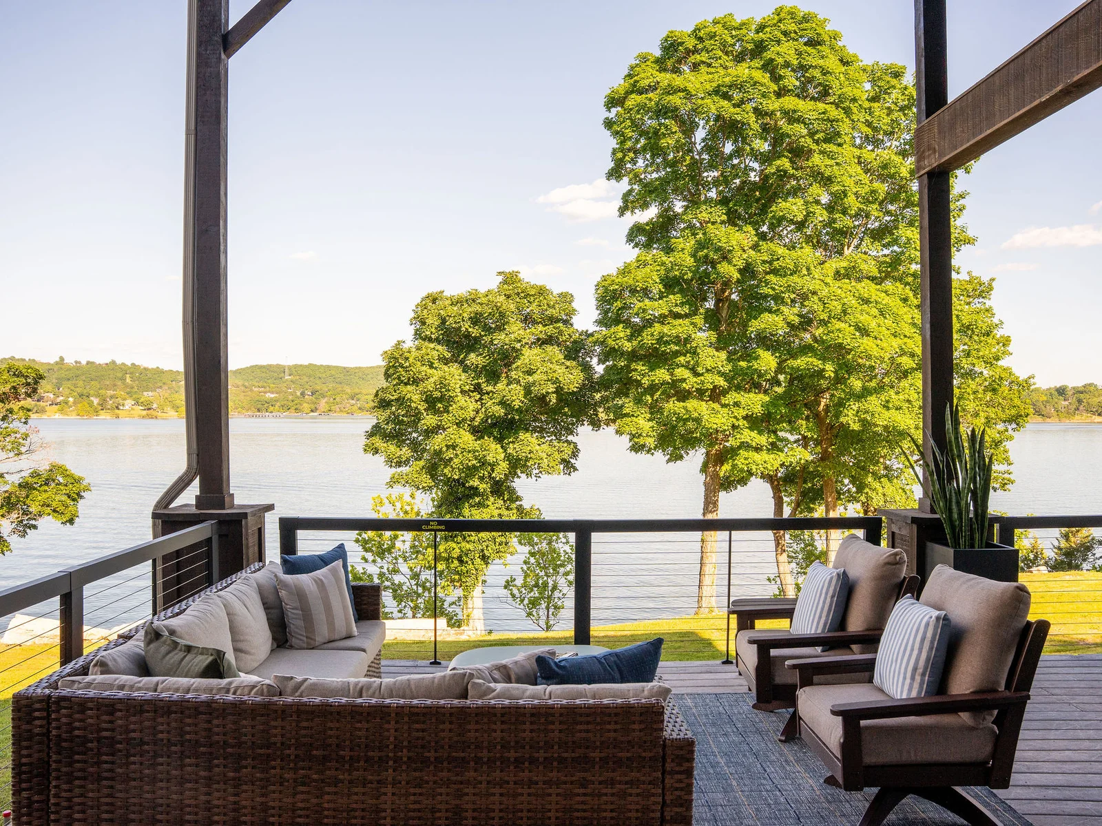 Settle into outdoor movie nights with panoramic lake views and cozy seating made for relaxing together.