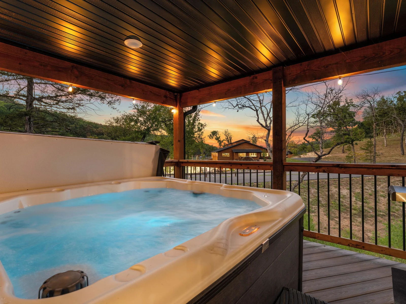 Hot tub at night, nearby amenity lights make it feel special on the deck at night.