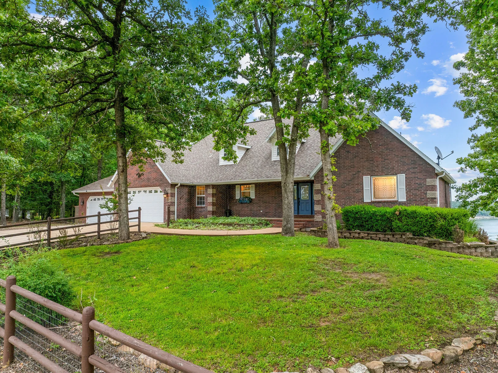 Brick and timber, surrounded by mature Ozark hardwoods — your house sits on a quiet residential loop inside the Ozarks, just situated perfectly for a beautiful lake view.