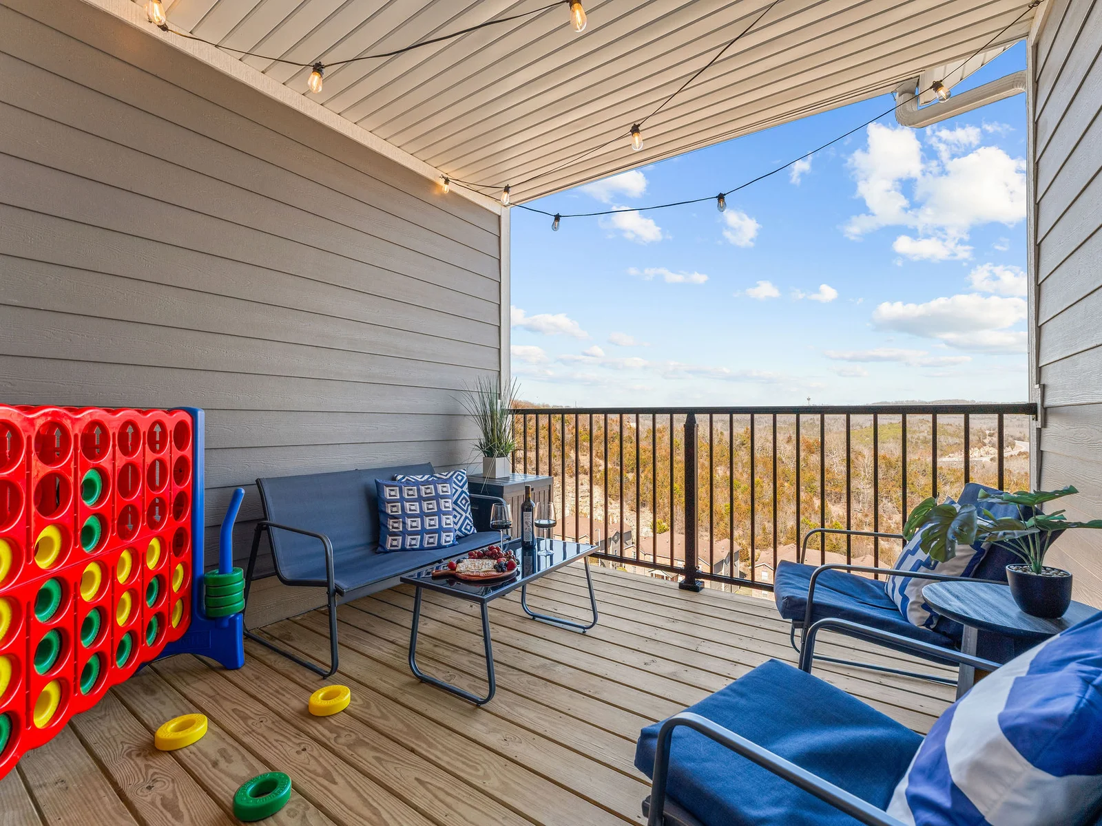 Take your morning coffee out here while the mountains wake up — the private balcony with seating for the group, open air, and no schedule. Pull up a chair and let the Ozarks do their thing.