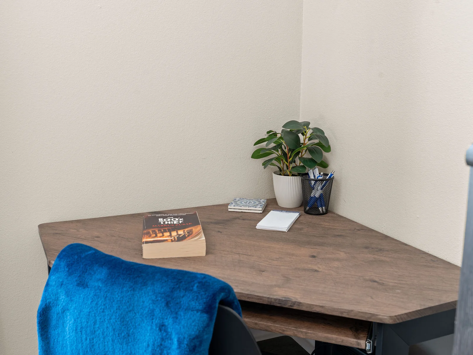 Your dedicated workspace sits in a quiet private corner — desk, chair, enough separation from the family room to actually get things done if you need to.