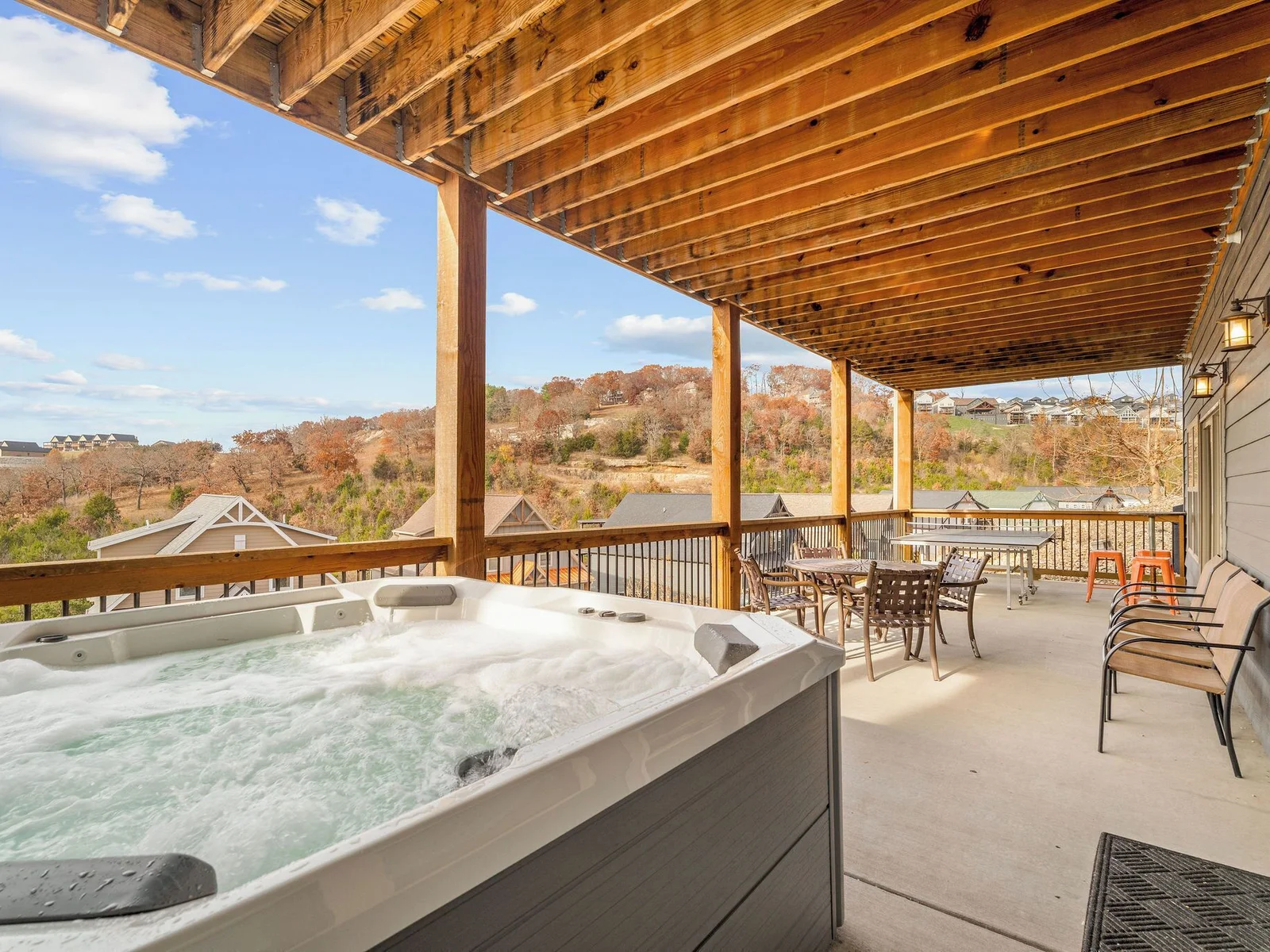 The hot tub is right off the bottom-level living room w/ spectacular lake views