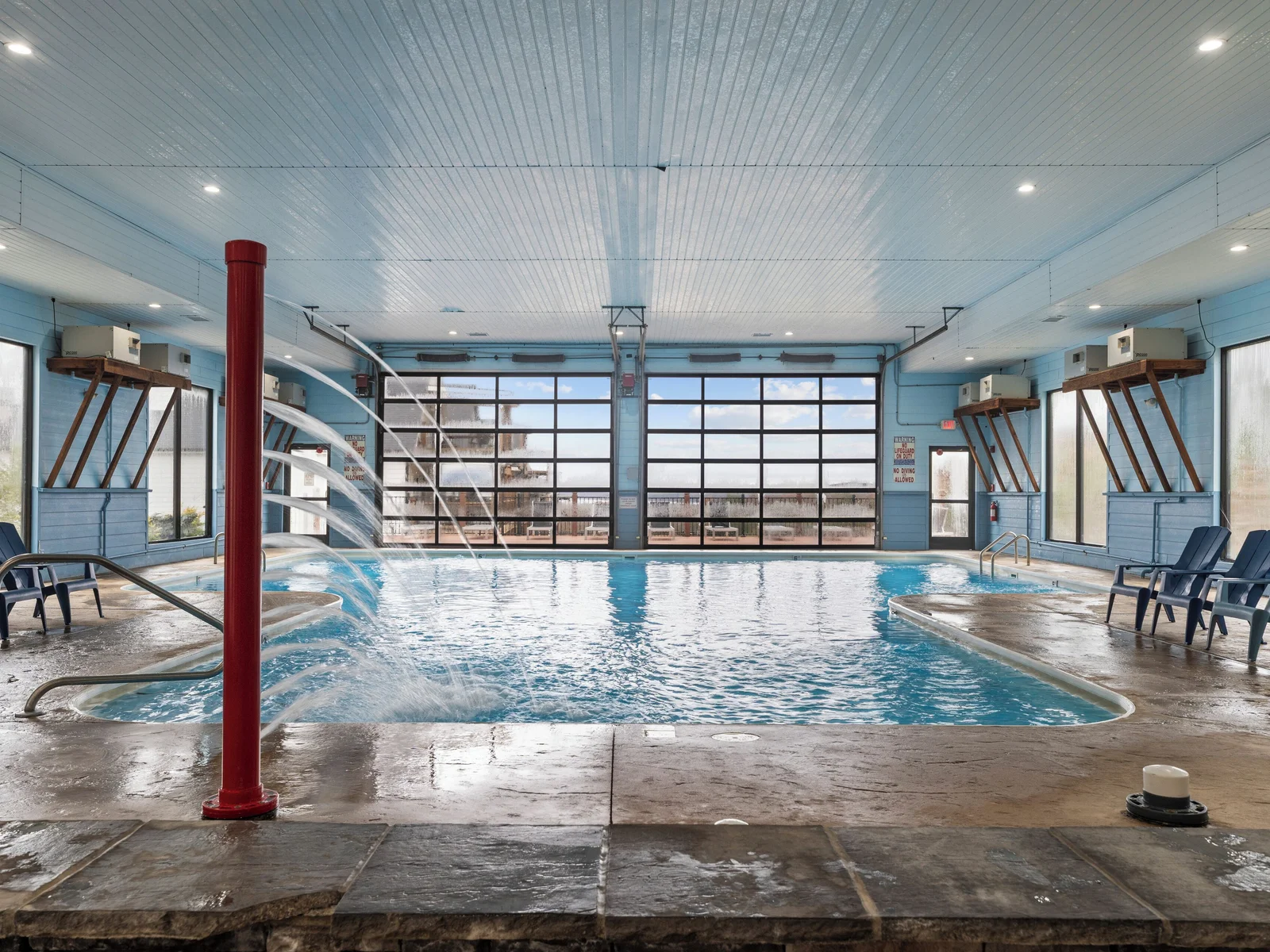 Indoor pool. Heated, and fun kid friendly features. Bathrooms, lounge chairs, and dining tables. Open year round.