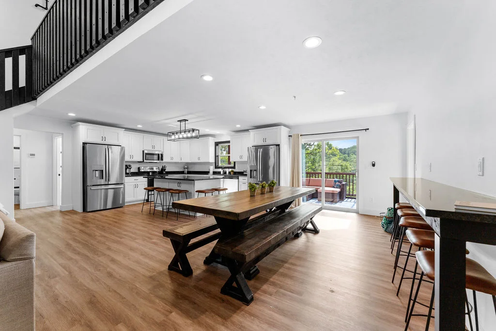 Open dining/kitchen space with seating for 18 at bars and dining table