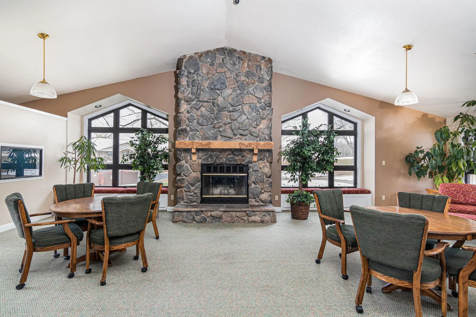 Clubhouse lounge with fireplace and comfortable seating.