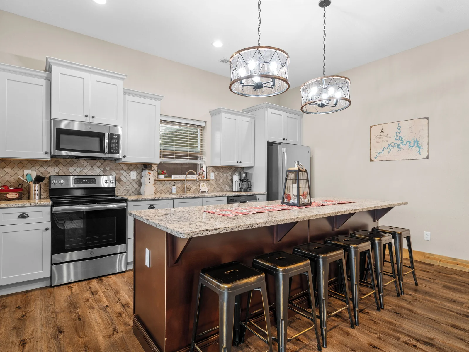 Lower level FULL kitchen. Refrigerator, dishwasher, oven/ceramic glass cooktop, microwave, drip coffee maker, Keurig, and Nespresso. Stocked with small appliances, cookware, bakeware, utensils, dishes, glassware, mugs, and more!