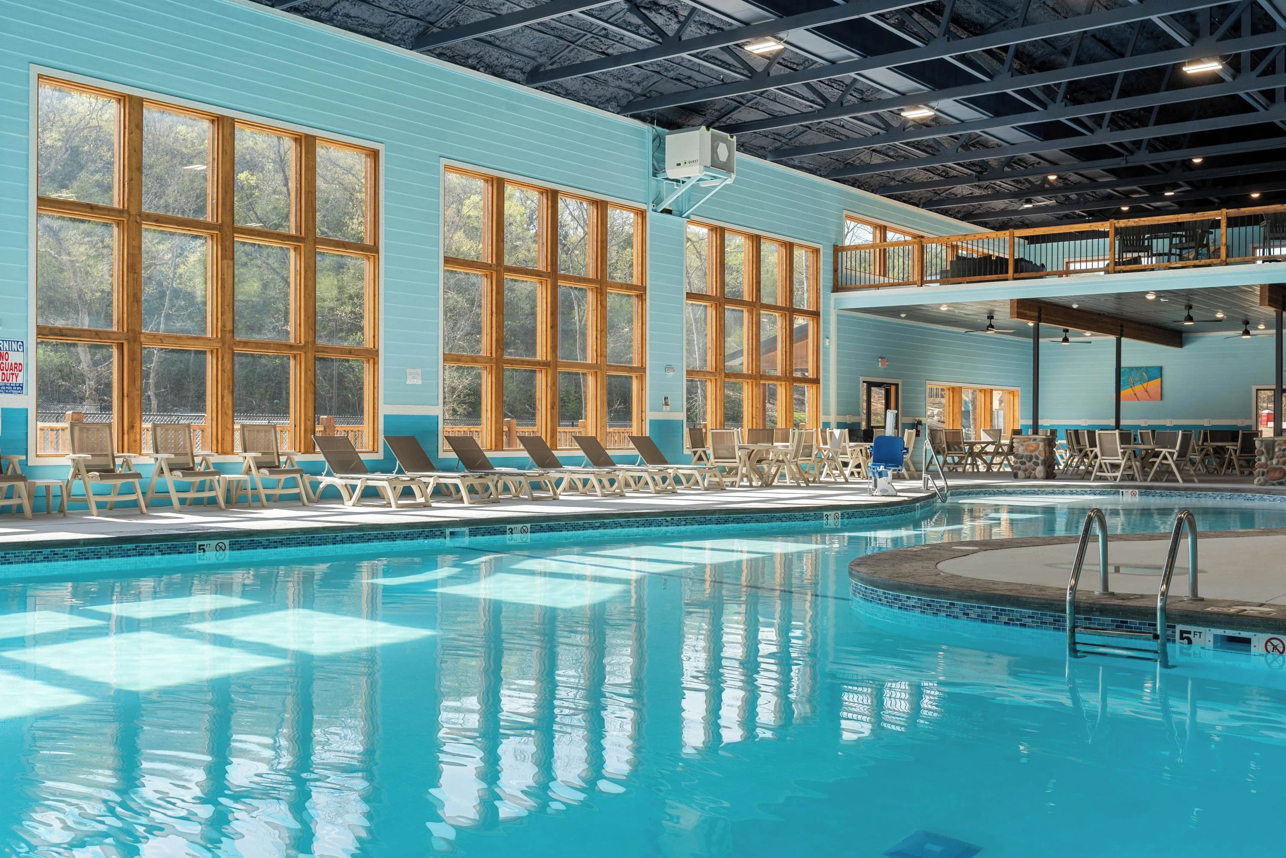 Indoor pool. Upstairs sitting area in view from pool.