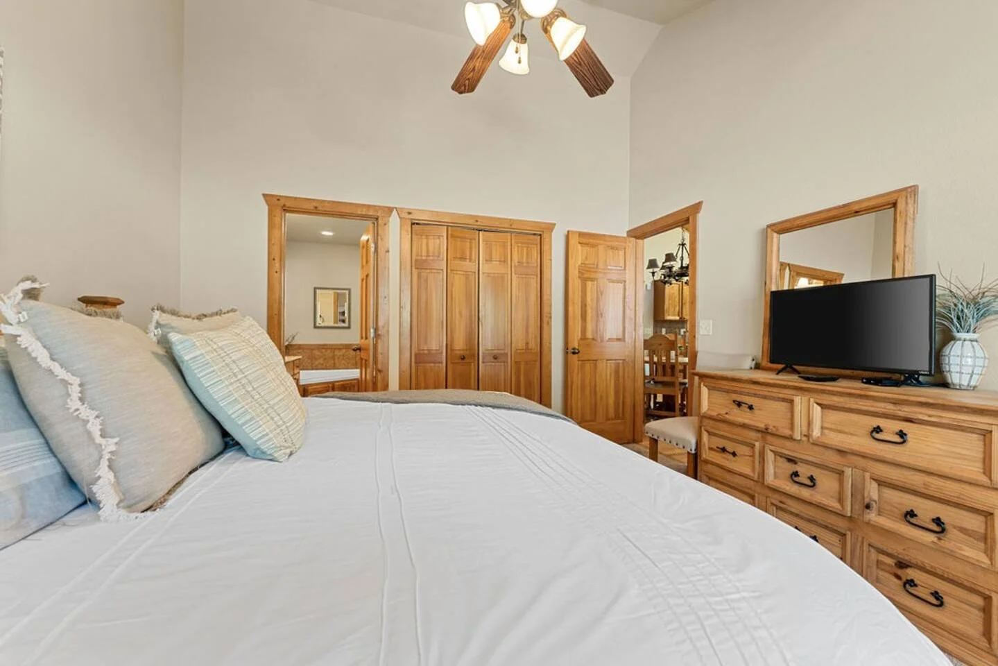 2nd master bedroom with king bed, a dresser and a smart tv with its own attached master bath