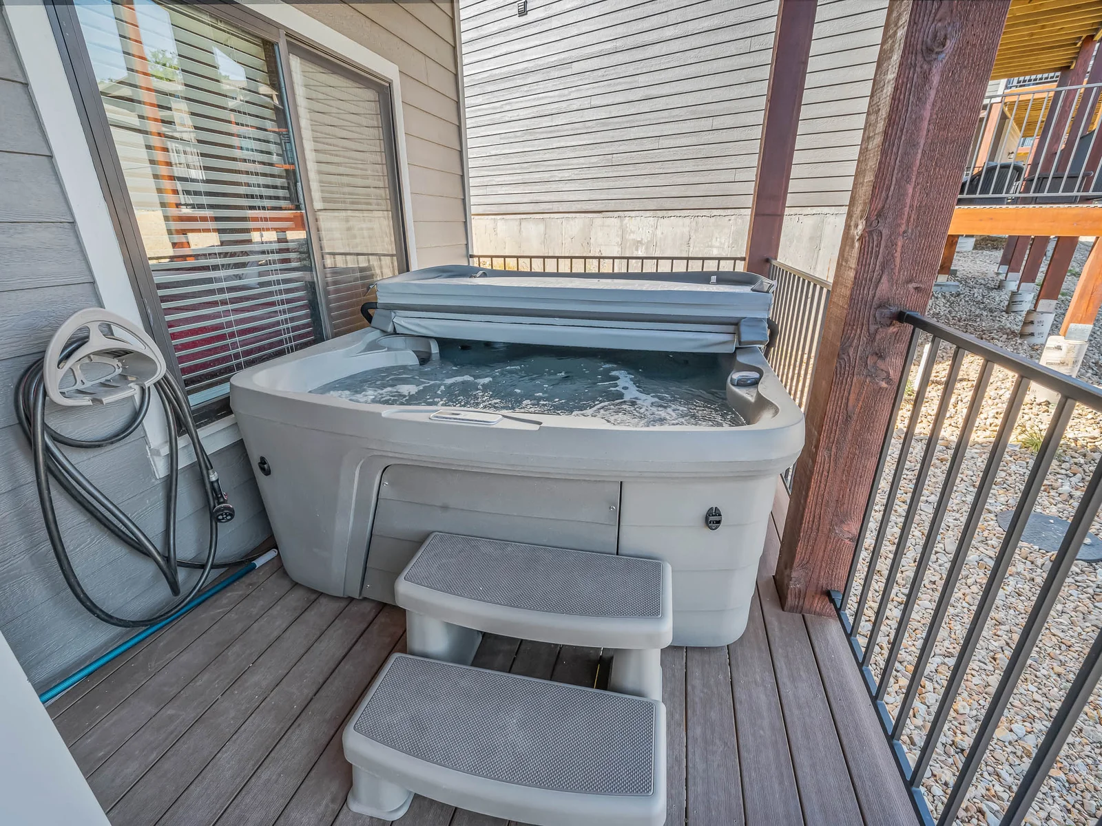 Private hot tub on the lower deck with a full size fridge for extra food and drinks