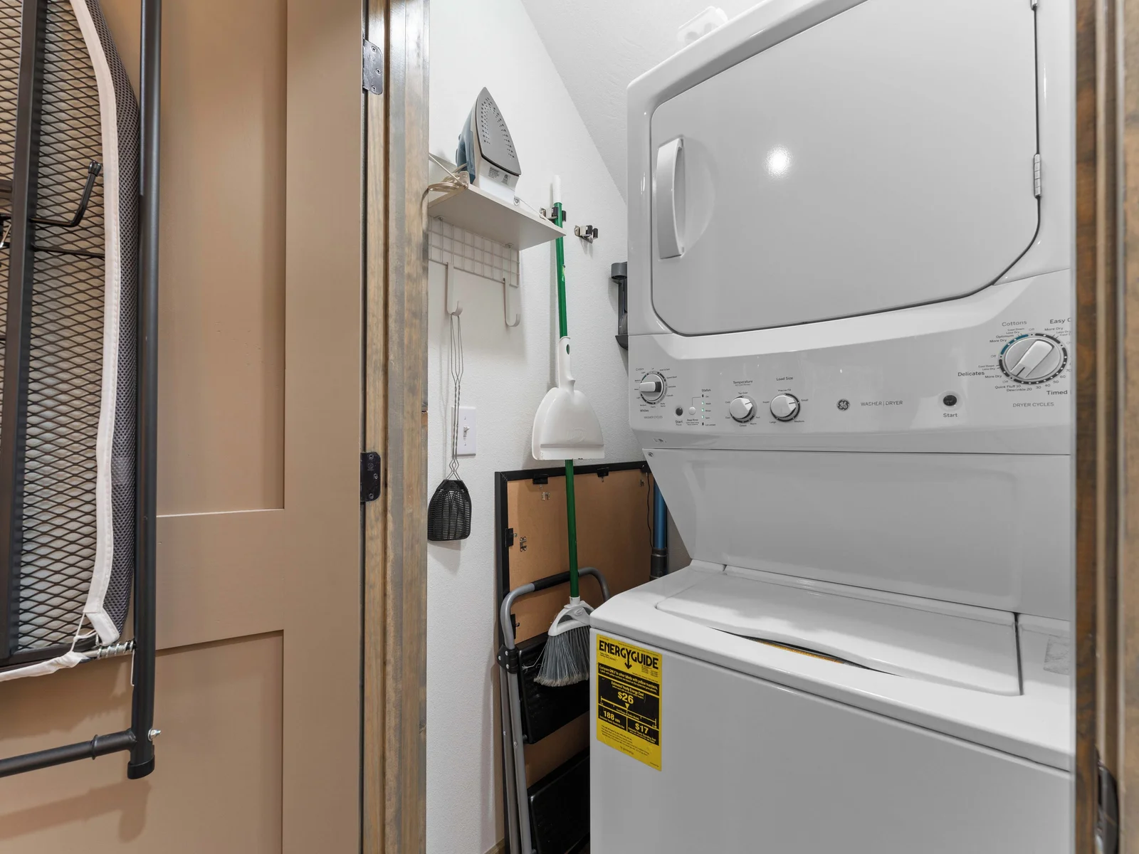 Downstairs laundry. Accessible from living area. Ironing board and vacuum in this closet. Pods and dryer sheets provided.