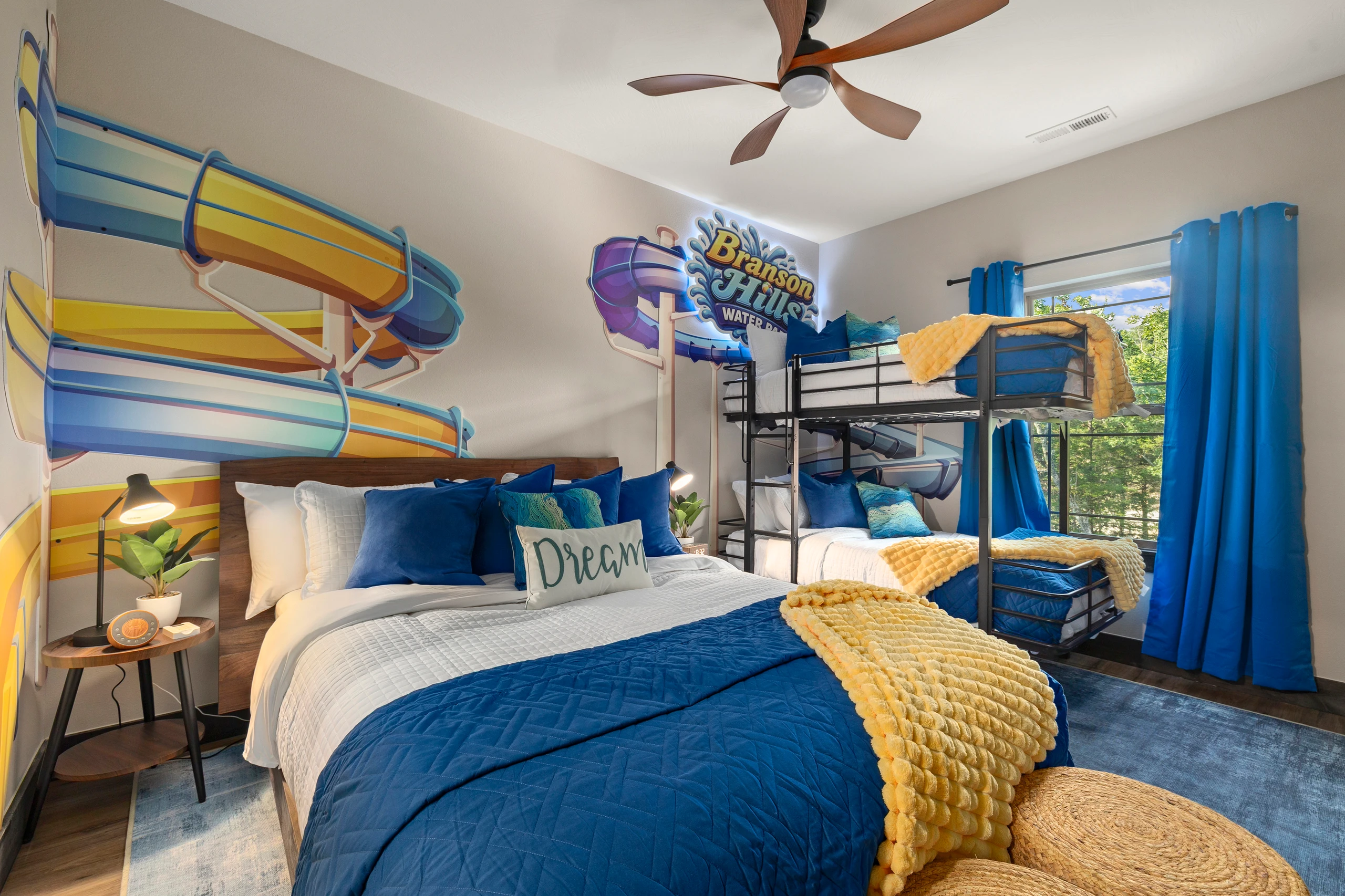 Splash into the Water Park Room, a queen bed plus bunks under waterslide murals.