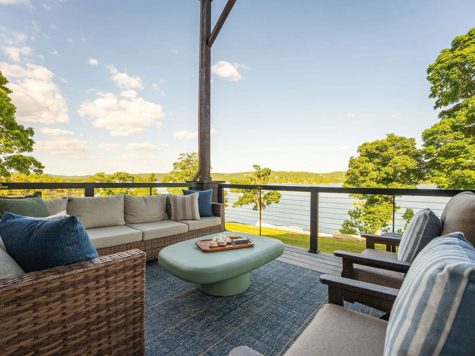 Unwind on the covered deck with comfortable seating and uninterrupted views of the lake.