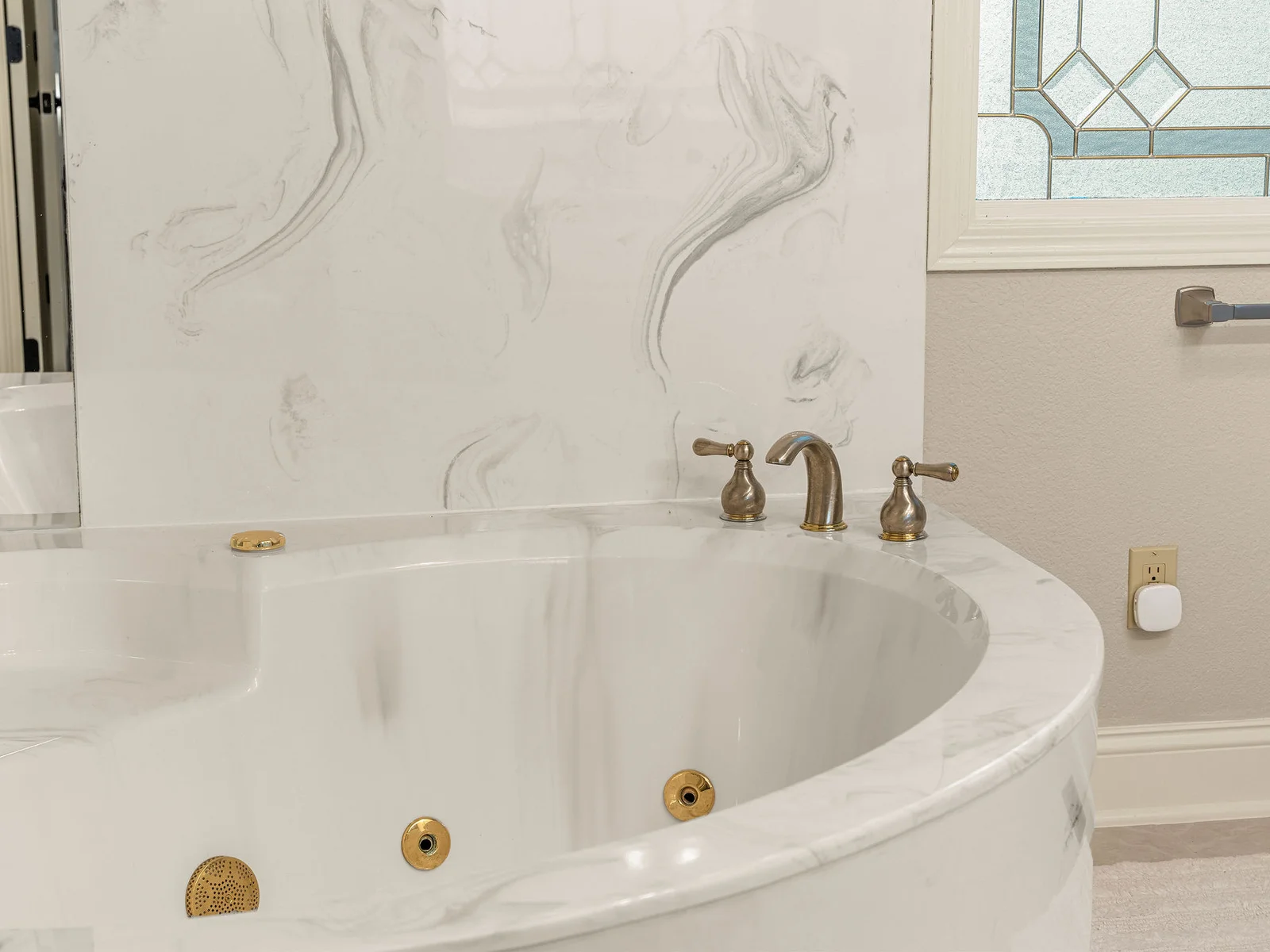 The whirlpool jets on the jacuzzi tub, the marble surround, and the brass fixtures up close — a few details worth knowing before your first soak.
