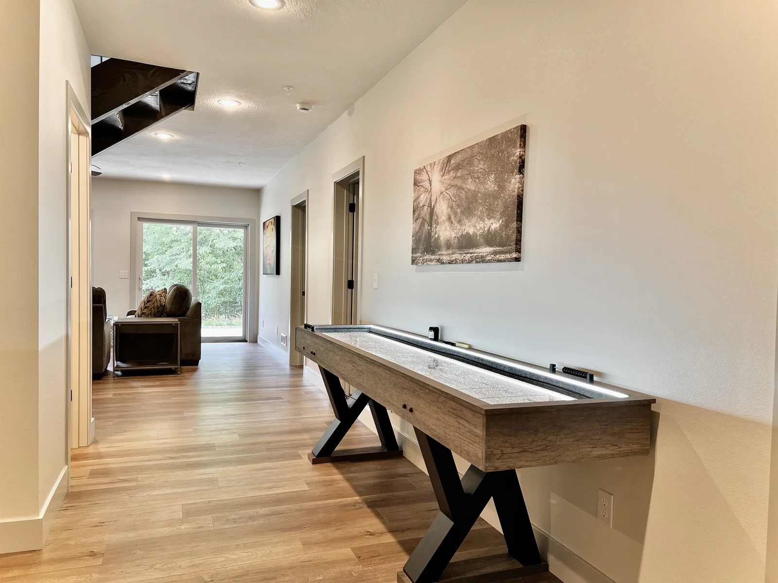 Shuffle board table located in the game room!