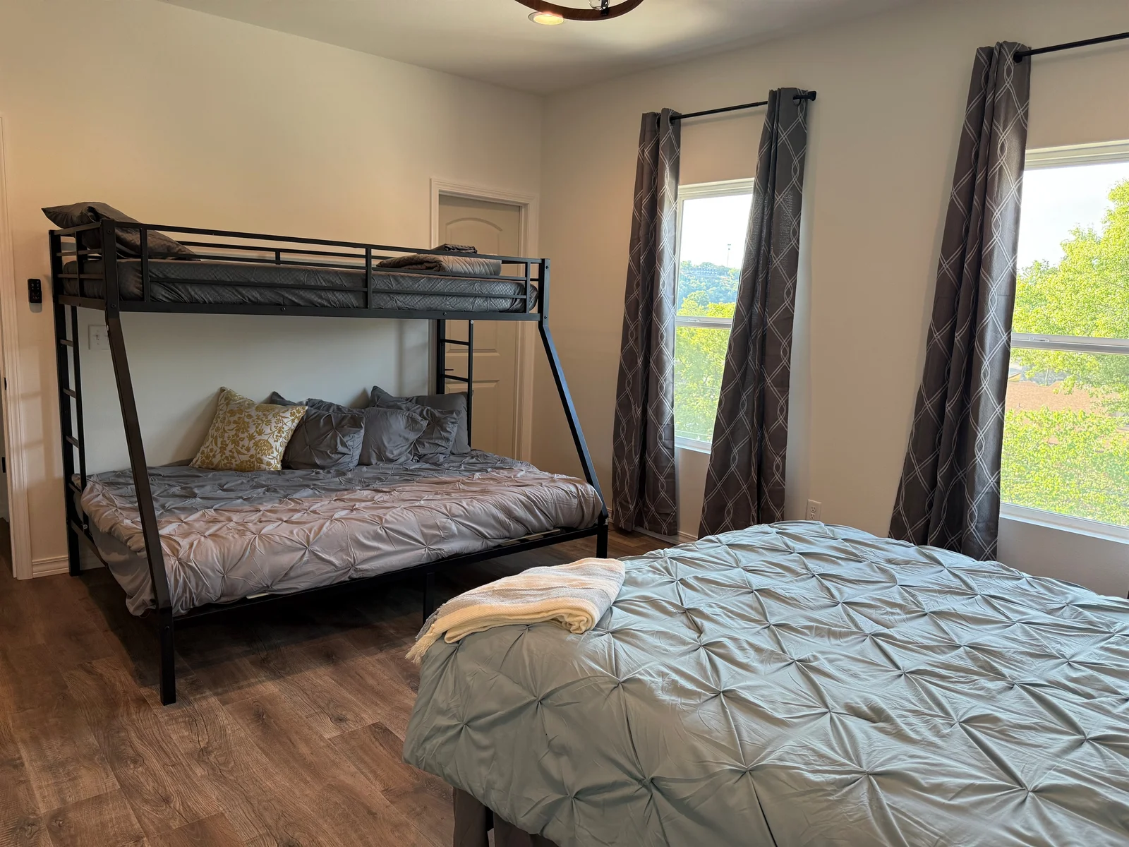 Bedroom #3 has a Queen bed and a set of Bunks. Lower bunk in a Queen and upper is a twin xl. Room is large enough to provide this amount of bedding and still have room to move around. Dresser and night stands also in room