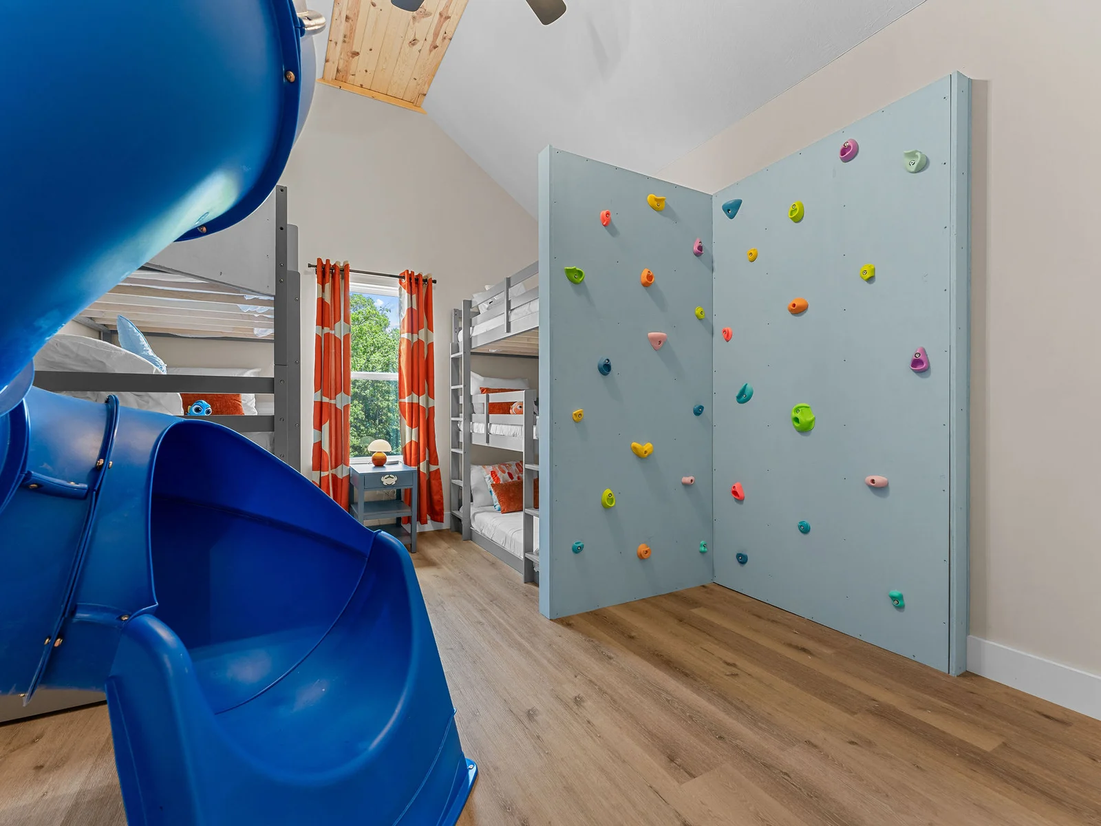 The ultimate kids' room! Six cozy bunk beds, a slide, and a climbing wall make every bedtime an adventure. 🌟