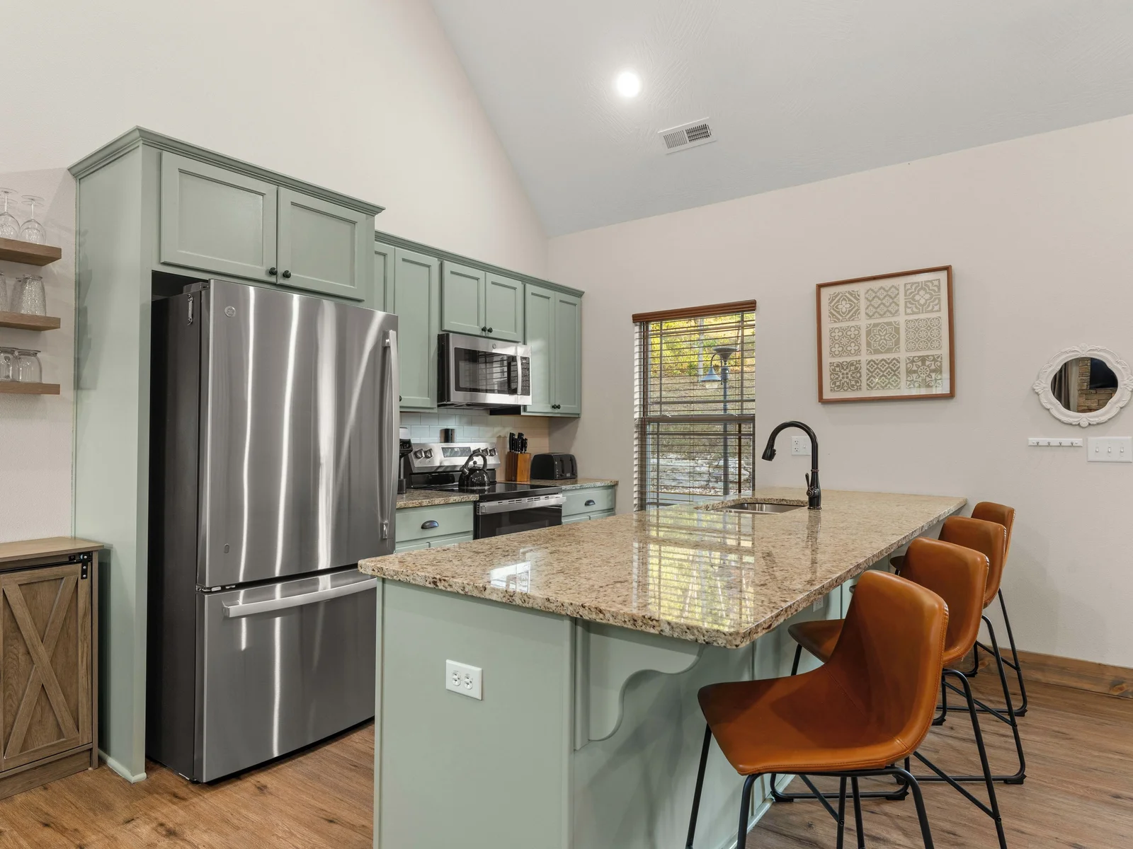 Open concept kitchen area with additional seating for 4 at the kitchen island.
