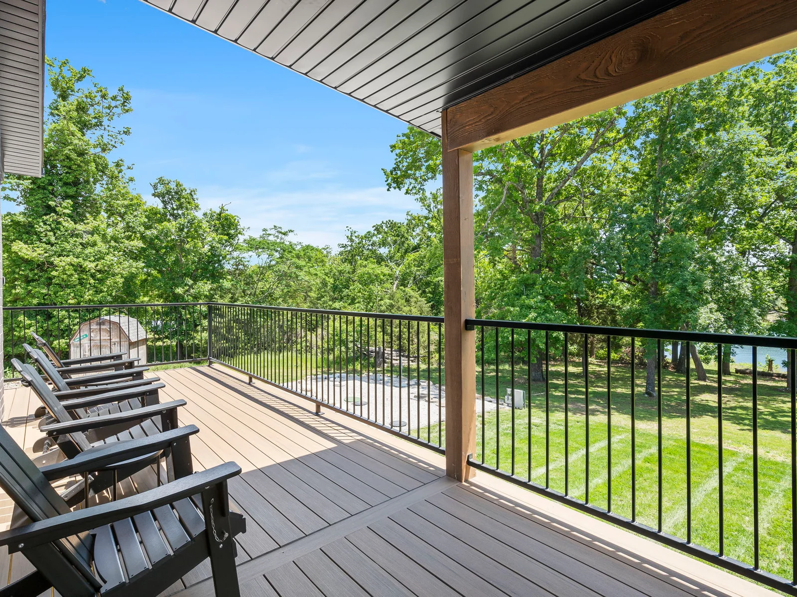 Upper deck with adirondack seating and composite picnic table. This is just off of the kitchen/dining space.