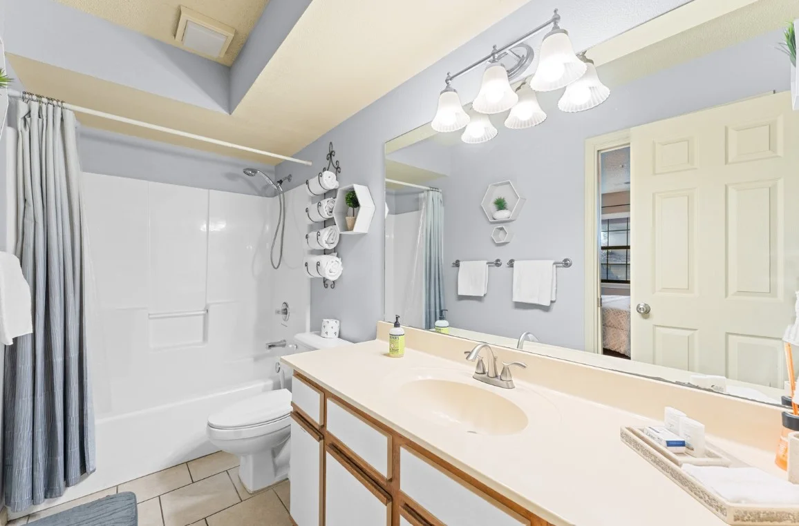 Second bathroom with large vanity and fresh towels provided.