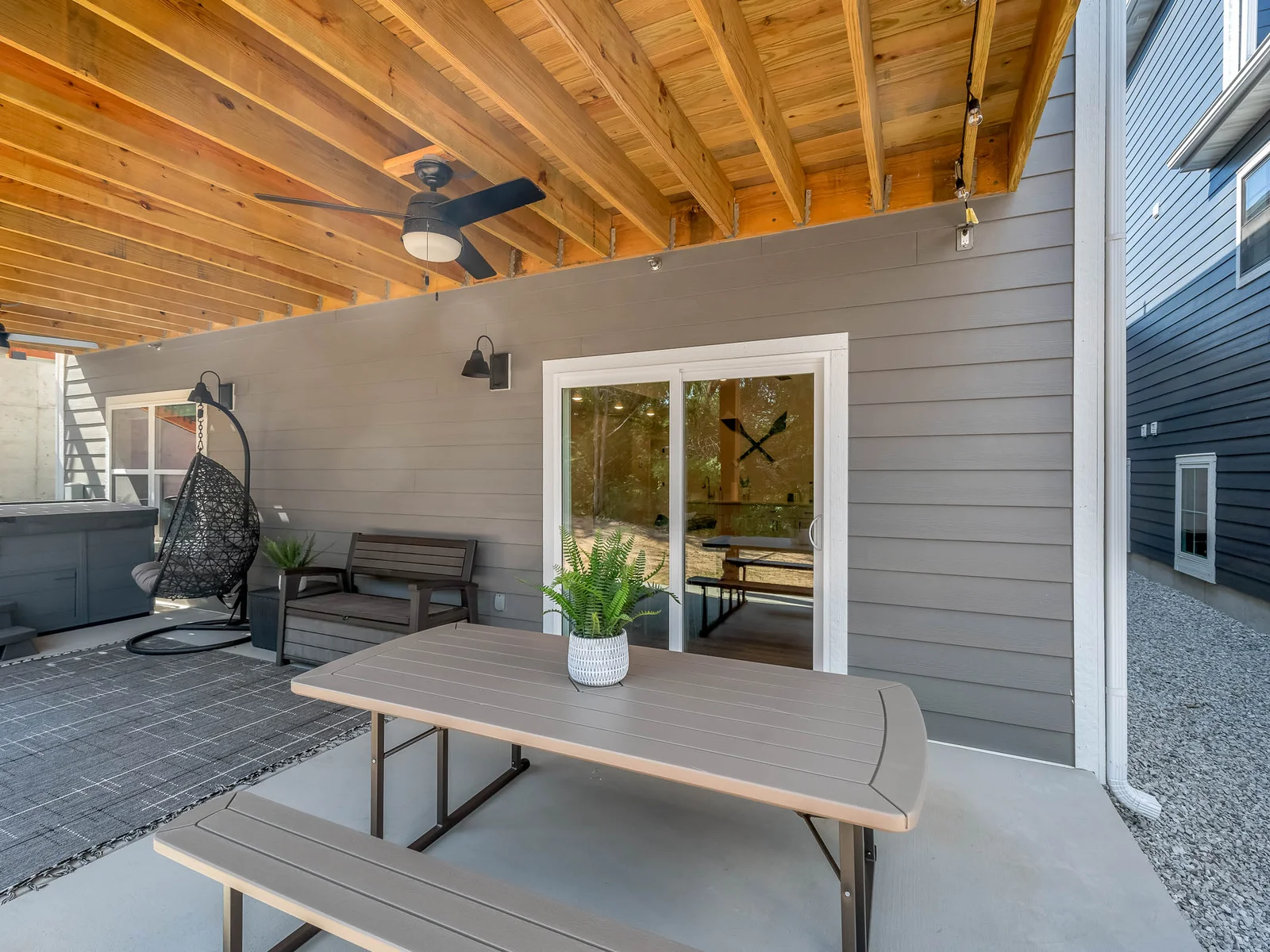 Lower level has picnic table and swinging egg chair