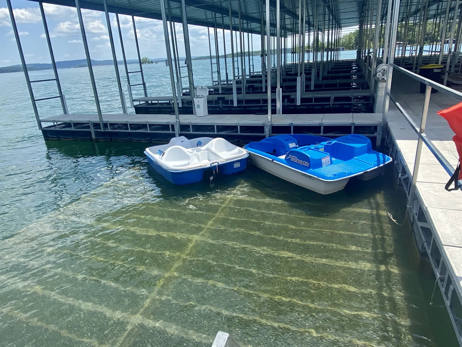 Kayaks and paddle boats available for checkout at the dock