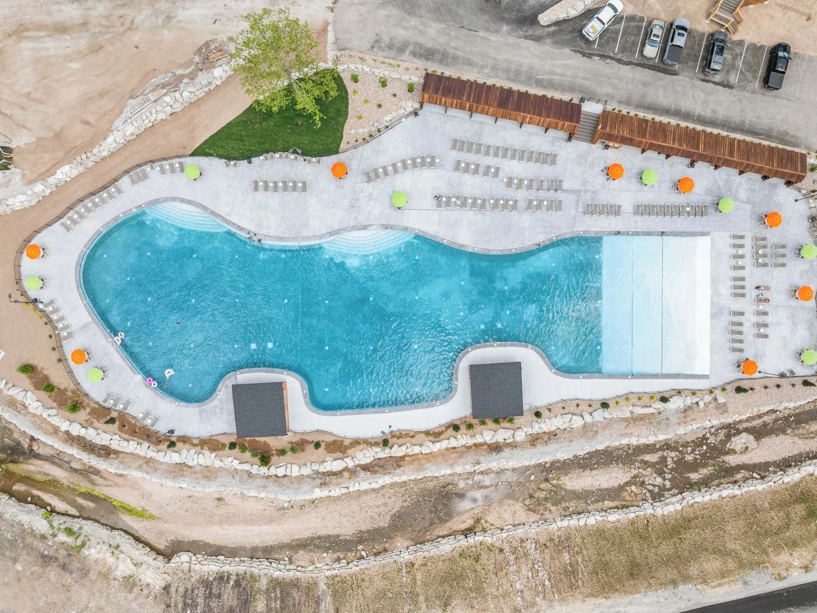 Very very large outdoor pool with chairs, umbrellas and cabanas available.