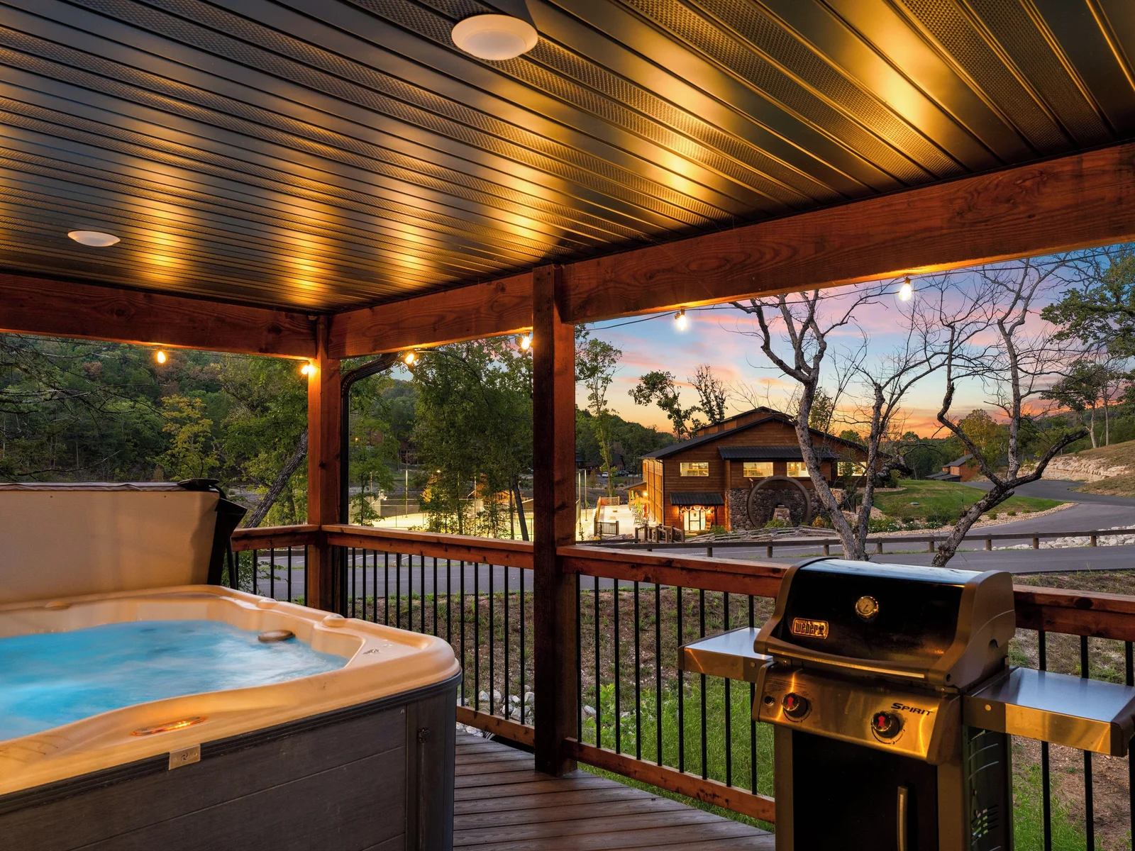 Beautiful view of indoor pool and outdoor sports courts at night with all the amenity lights on.