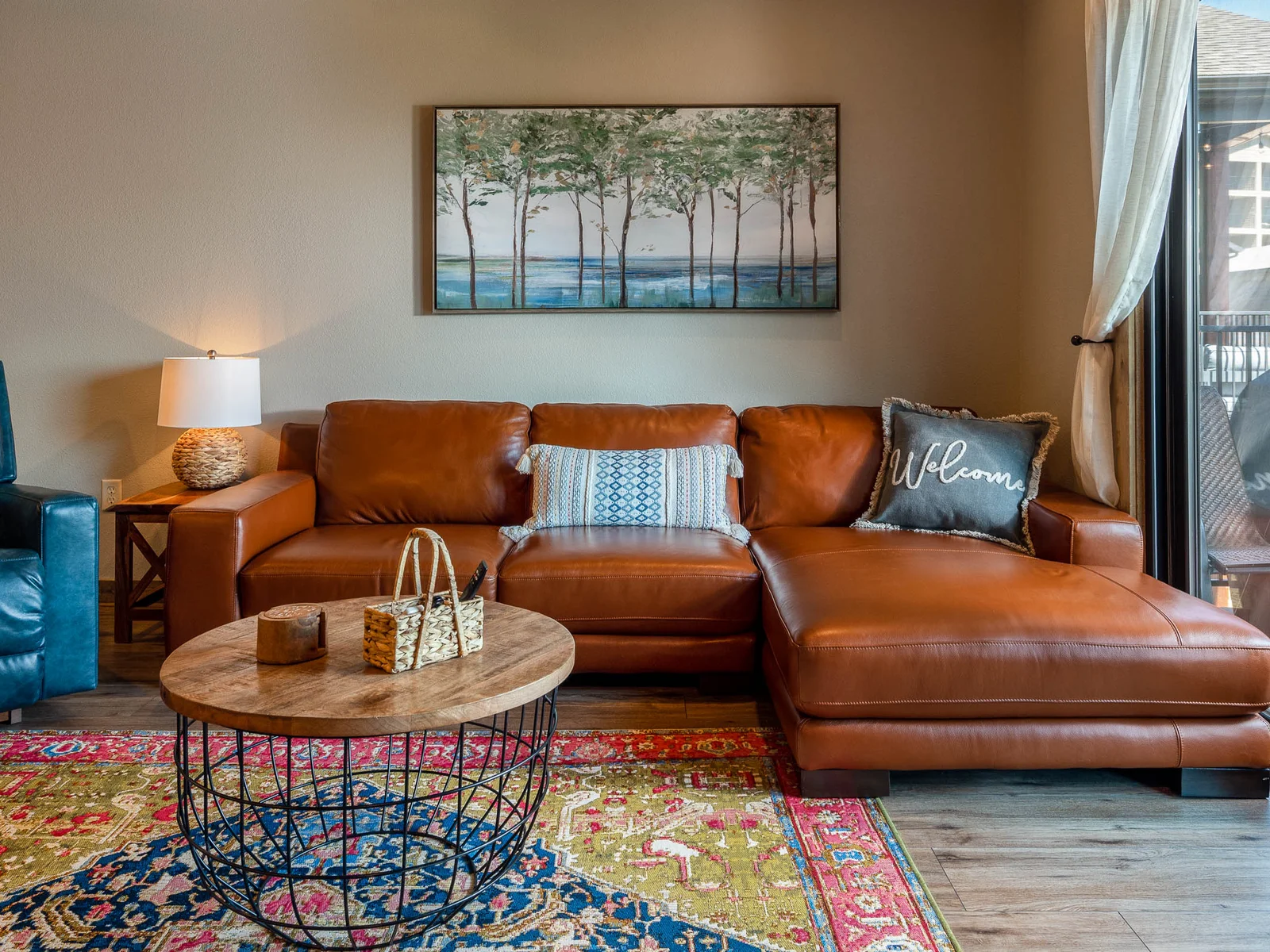 Beautiful seather sectional in the living area with sliding door out to upper deck