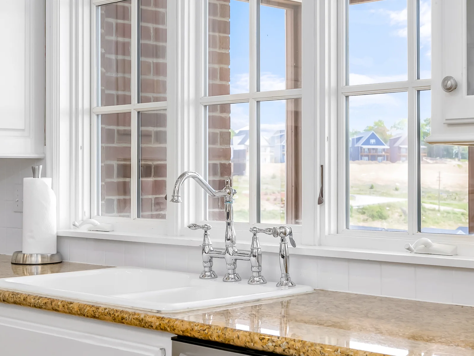 Kitchen window overlooks screened porch