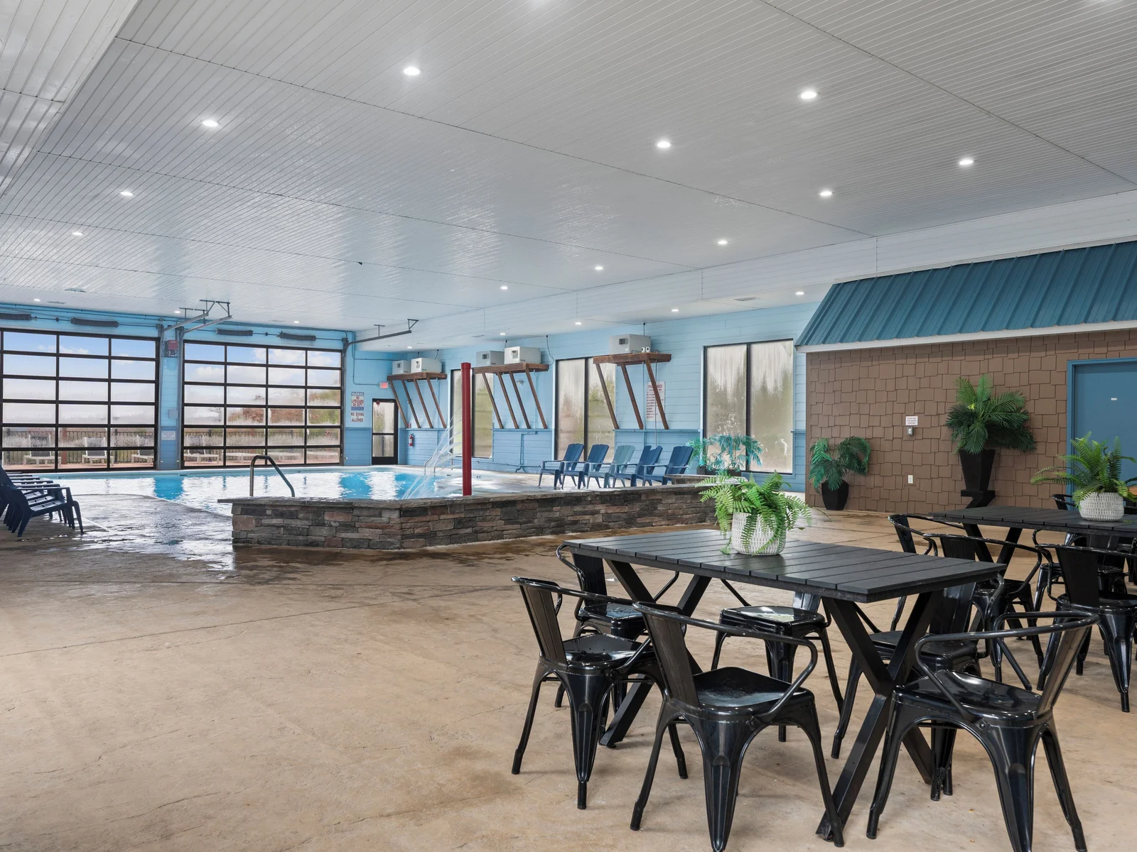 Indoor pool. Heated, and fun kid friendly features. Bathrooms, lounge chairs, and dining tables. Open year round.